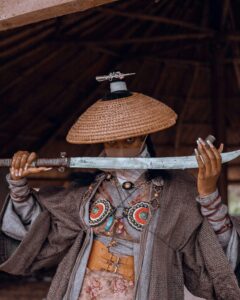 A fierce warrior woman dressed in traditional attire, holding a katana with intense focus.
